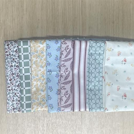 Set of fabric swatches with various patterns on a wooden surface