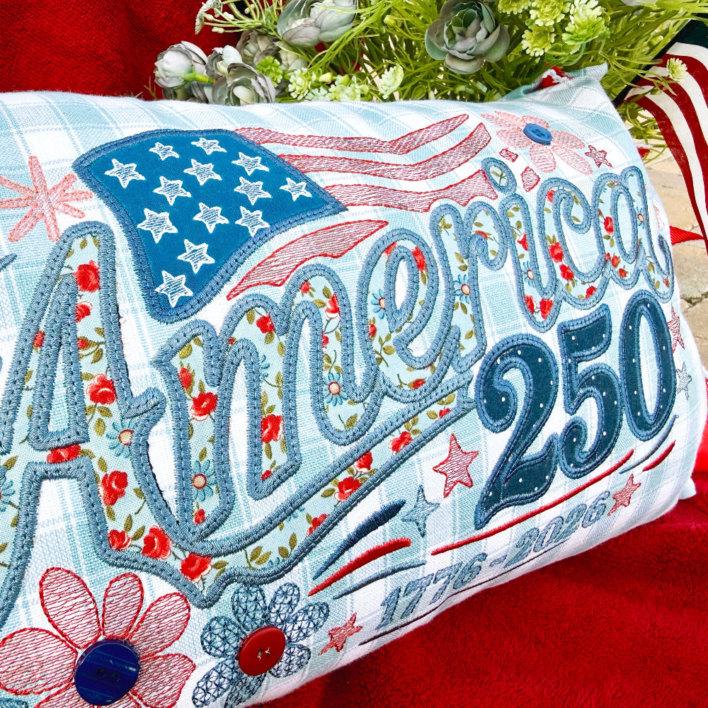 Decorative pillow with 'America 250' text and American flag design on a red background.