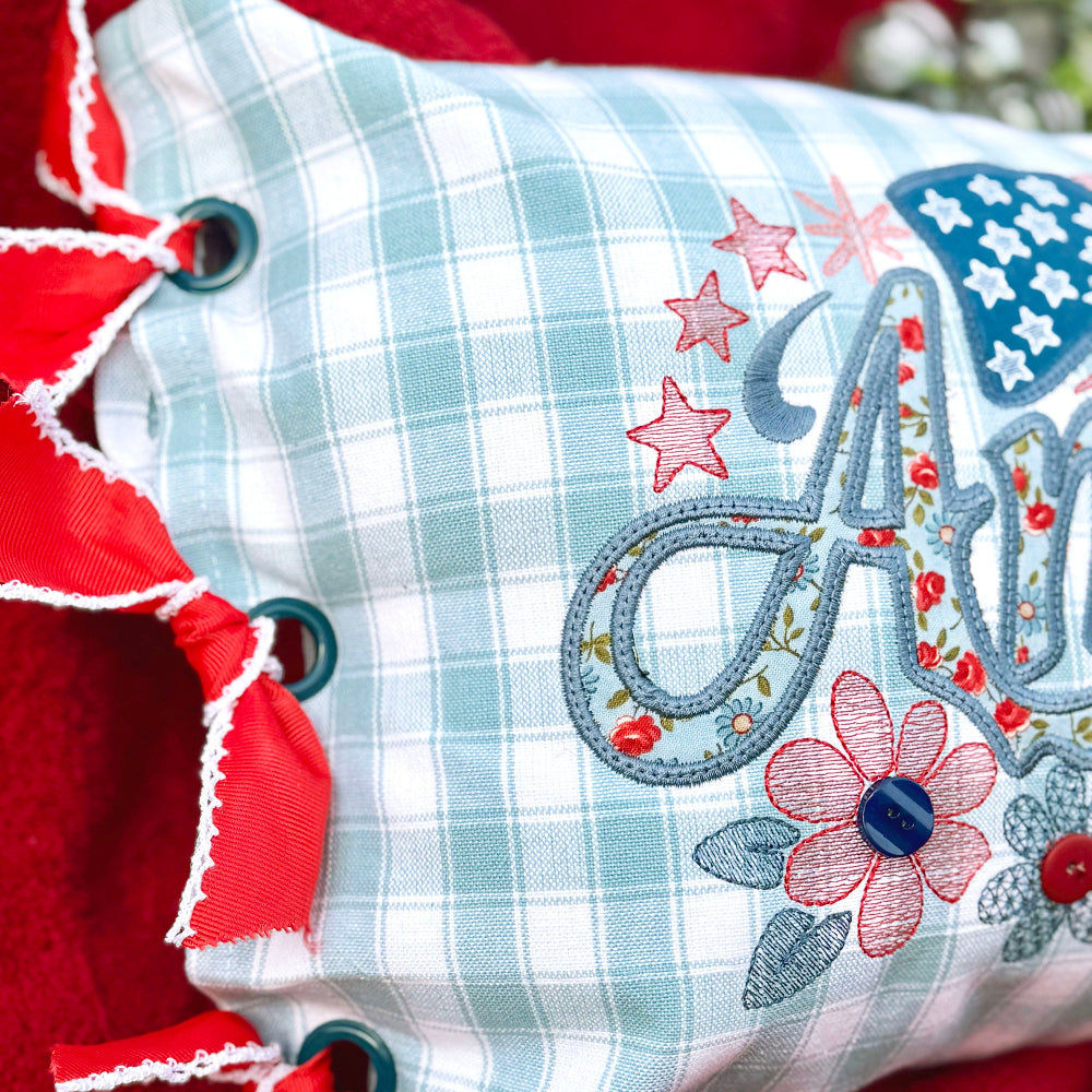 Decorative pillow with floral and letter 'A' design on a red background