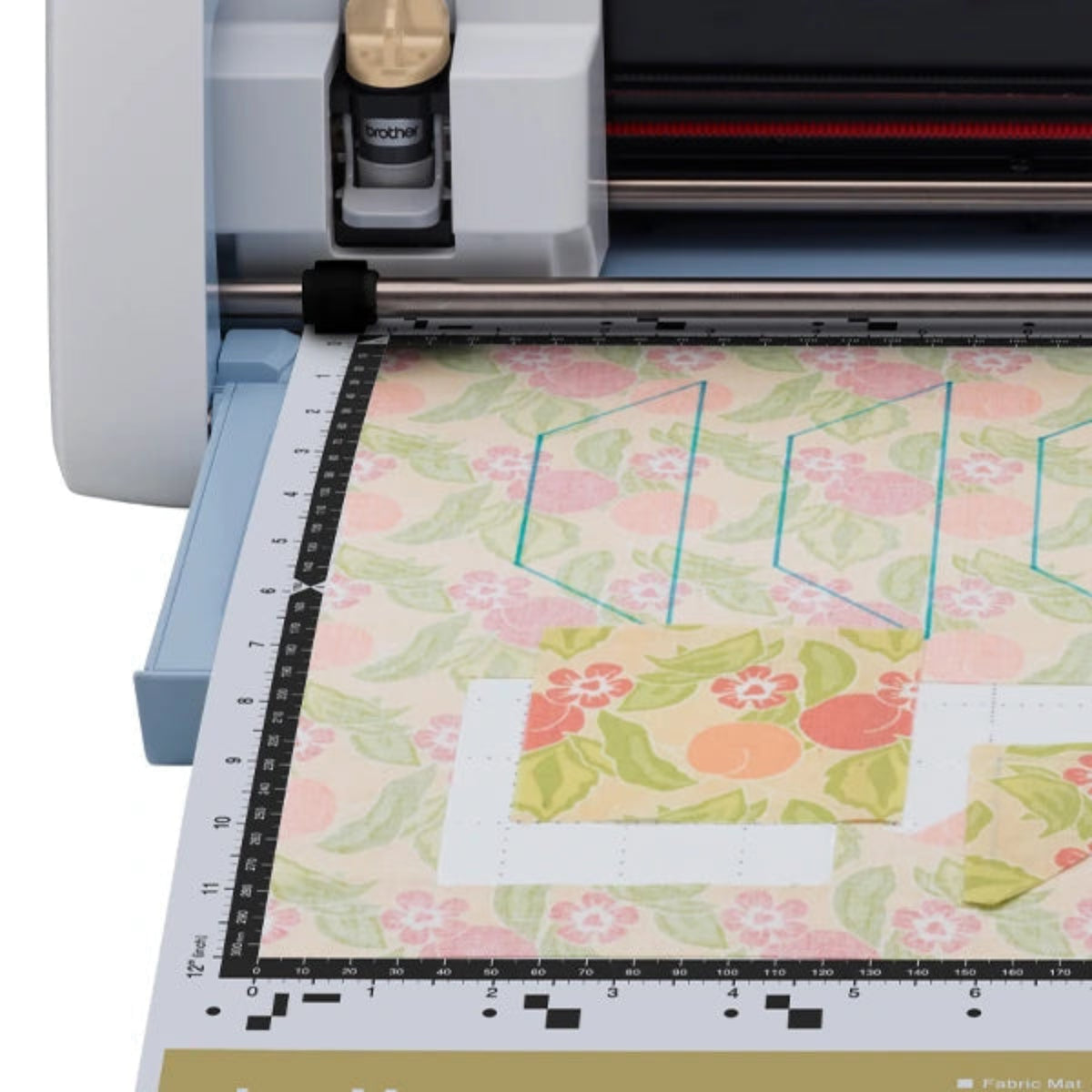 Cricut machine with a piece of floral fabric on a white background