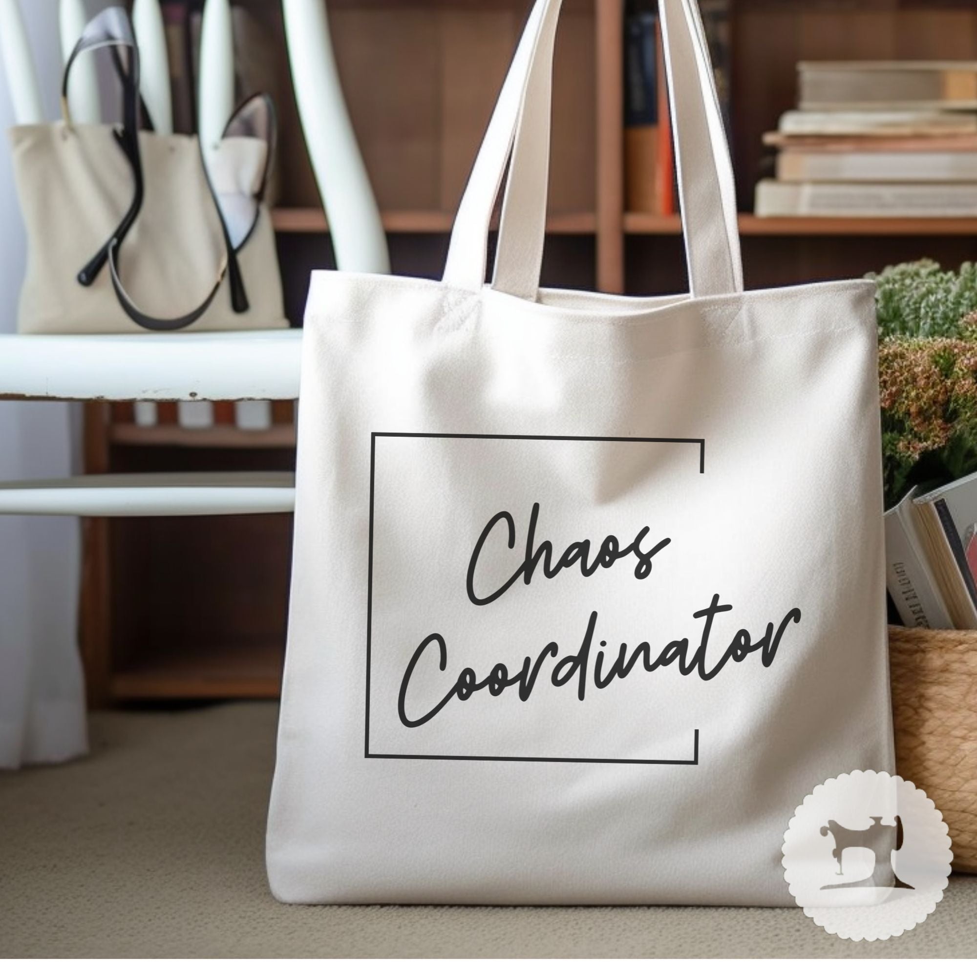 Beige tote bag with 'Chaos Coordinator' text on a blurred indoor background