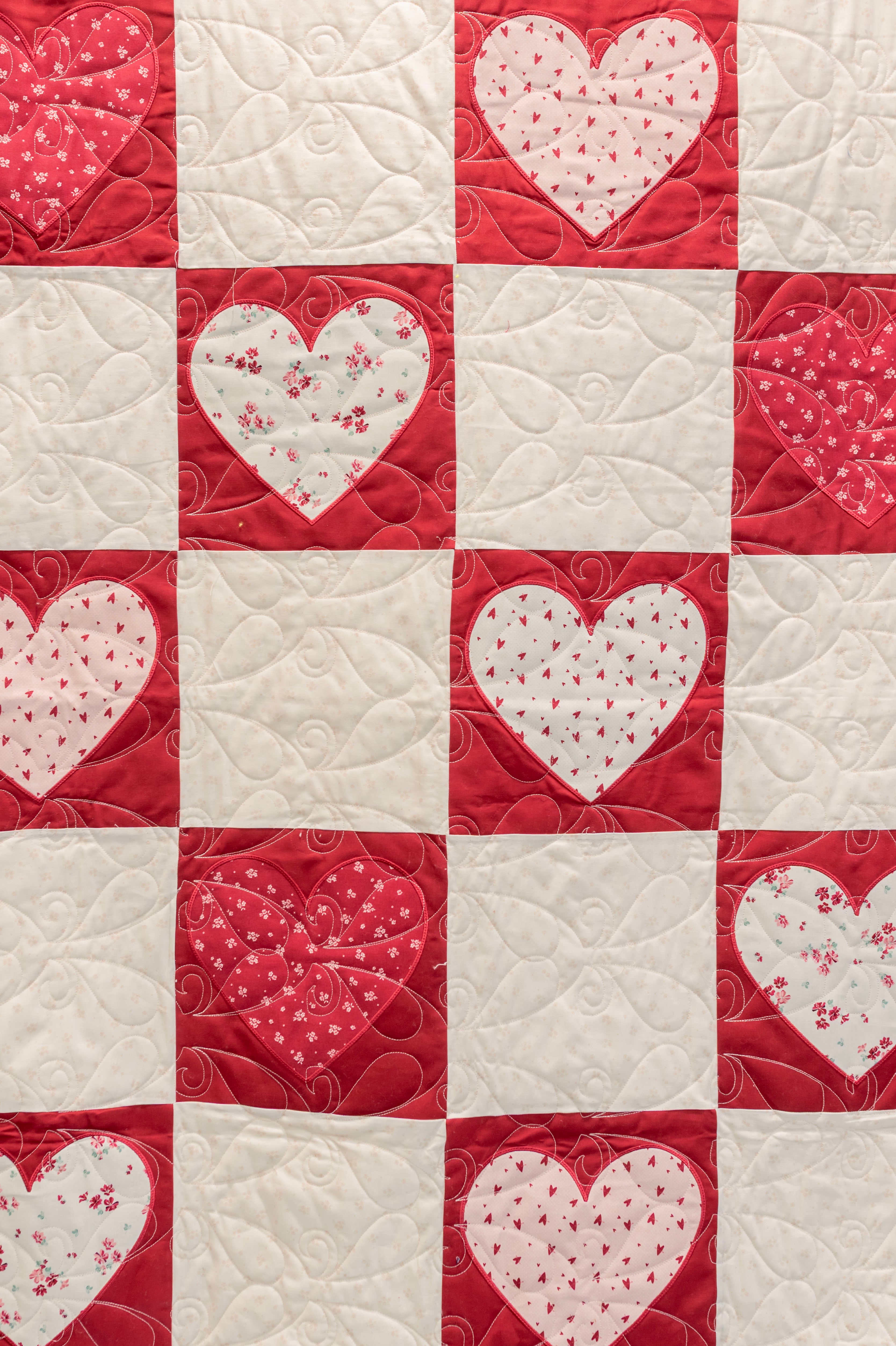 Quilt with heart patterns in red and white