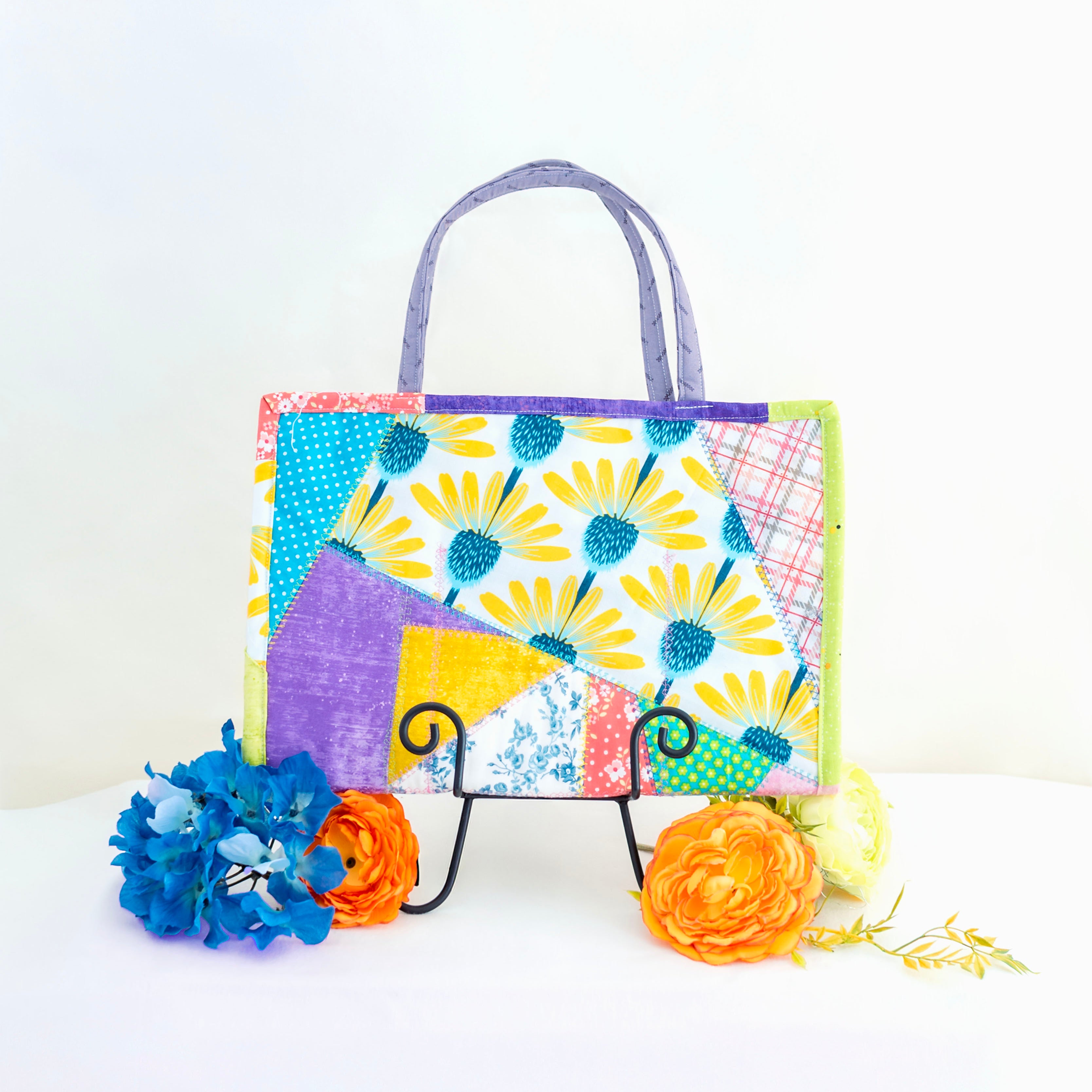 Colorful handbag with floral pattern on a white background
