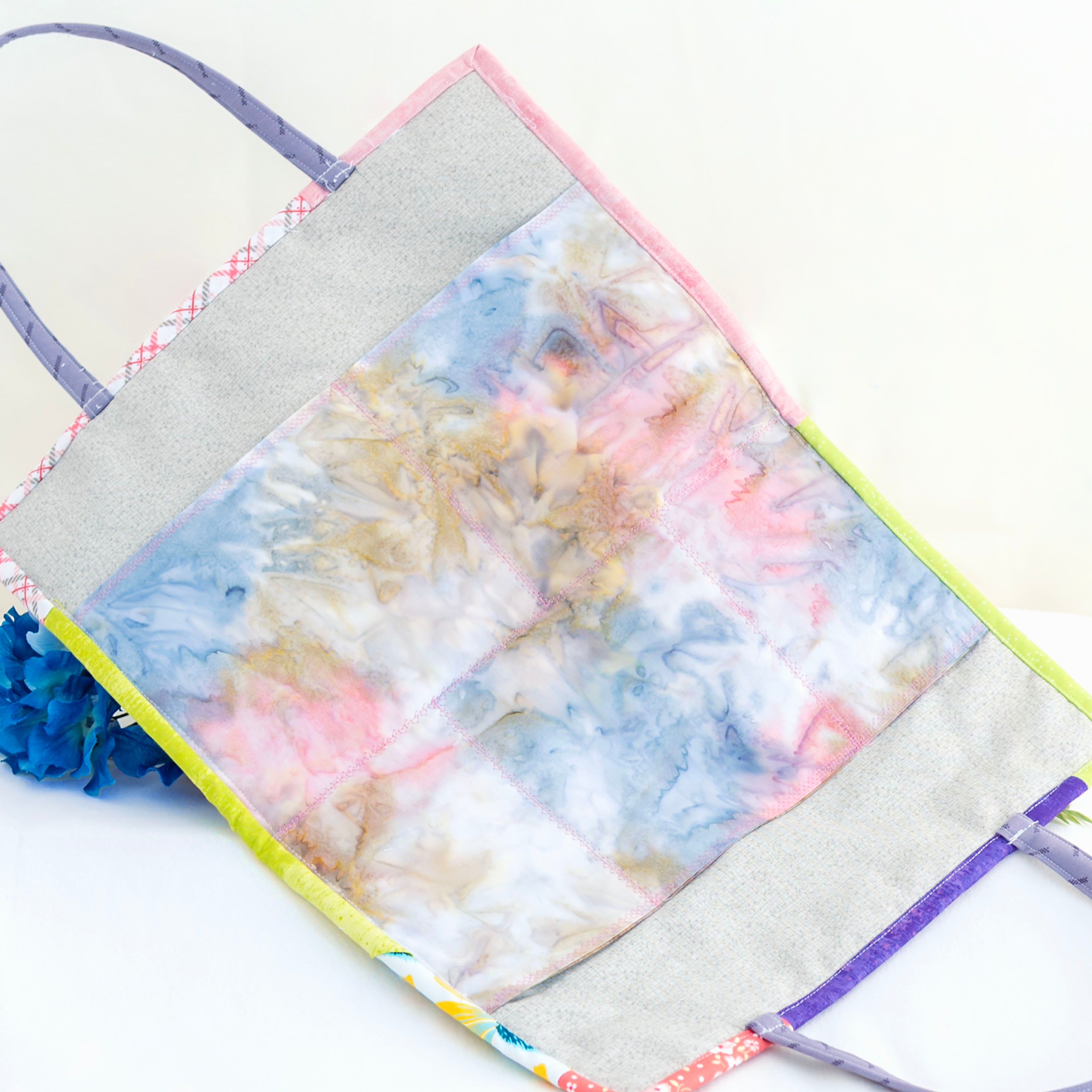 Colorful tote bag with floral design on a white background