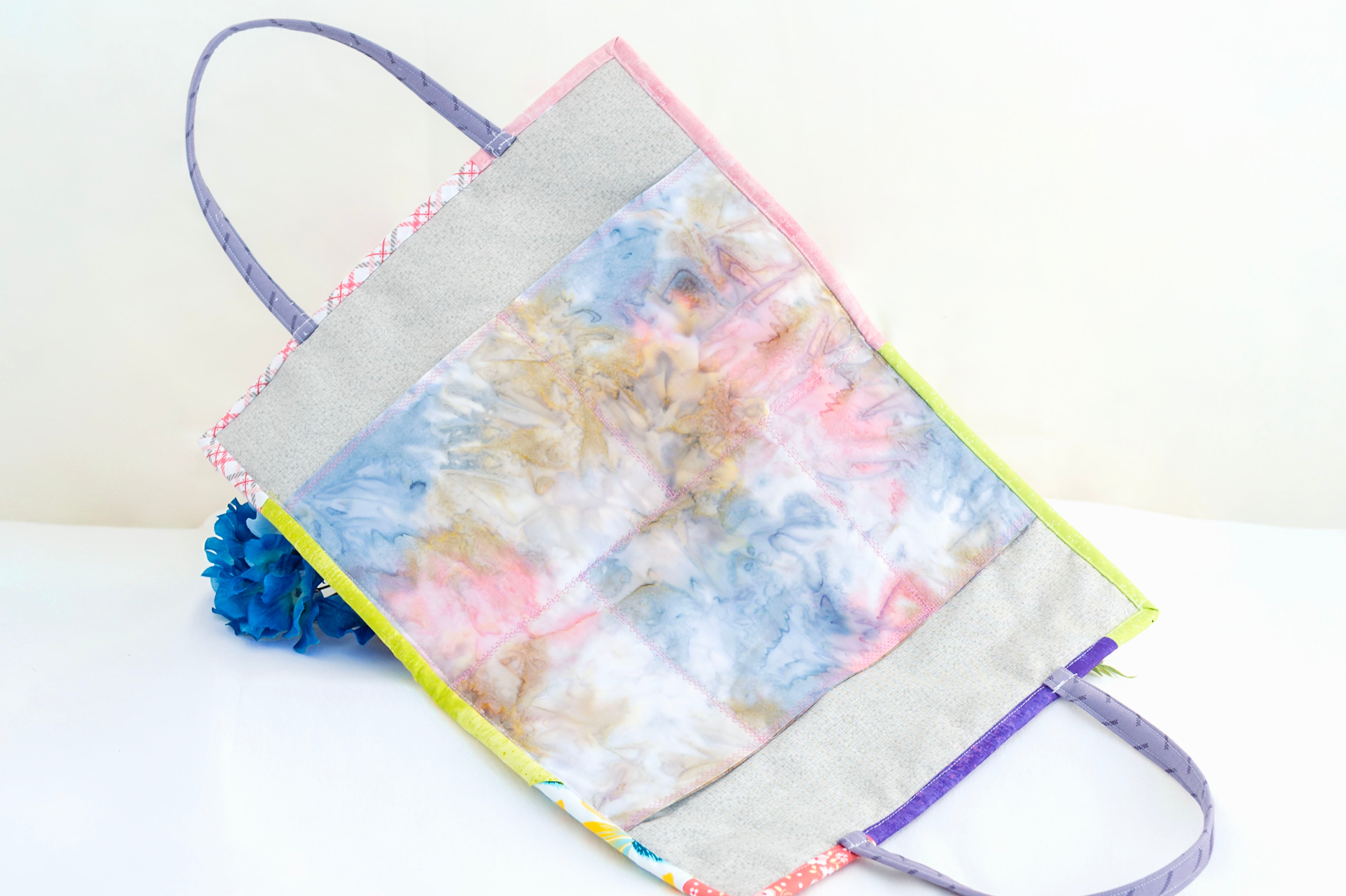 Colorful tote bag with floral design on a white background