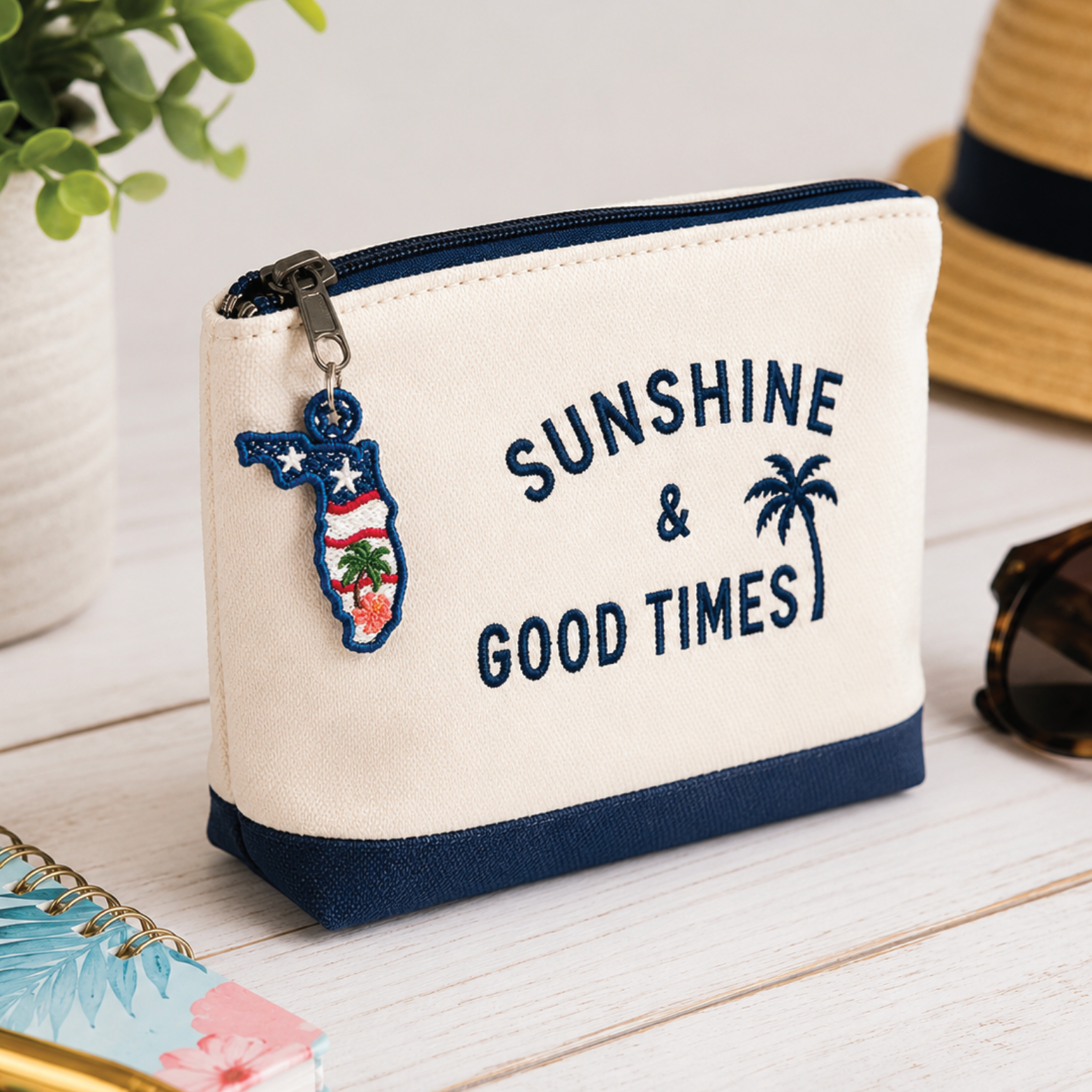 Small pouch with 'Sunshine & Good Times' text and a keychain on a wooden surface.