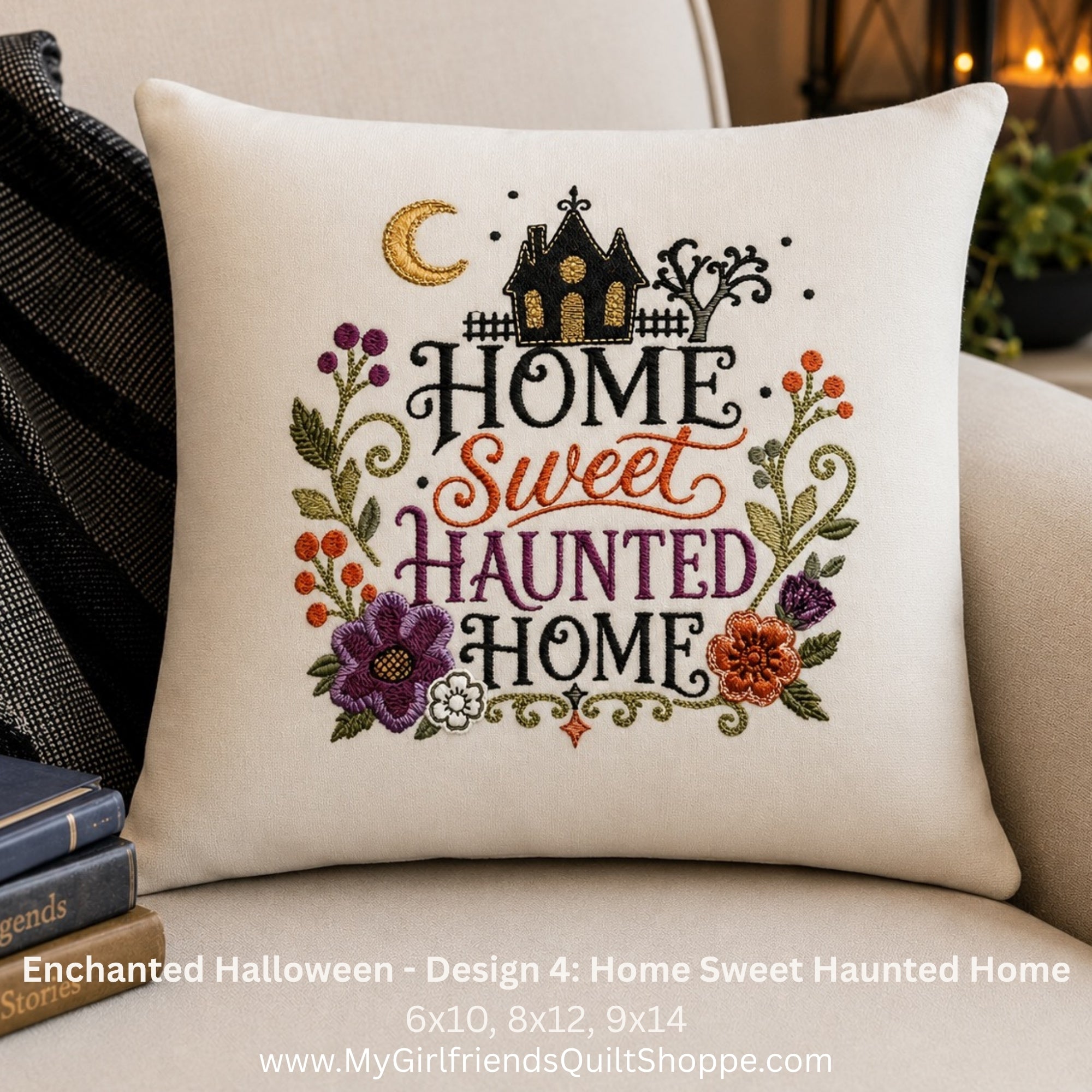 A square off-white throw pillow with an embroidered 'Home Sweet Haunted Home' design, styled on a beige sofa next to a striped blanket and books. The embroidery features a haunted house, crescent moon, and autumn flowers.