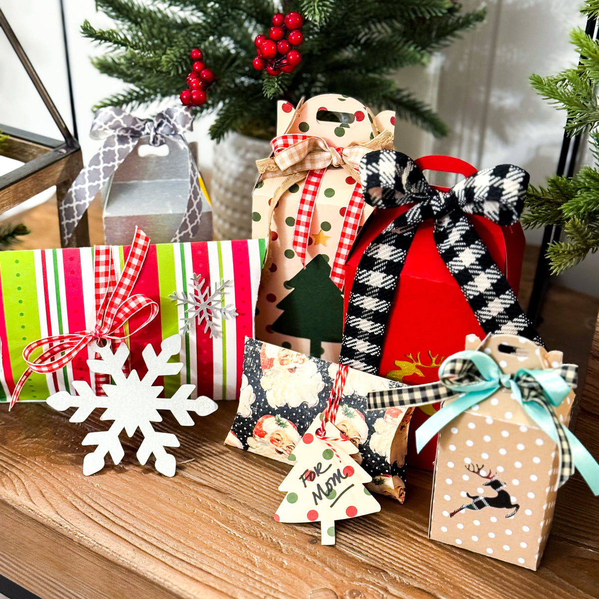 Decorative Christmas gift boxes with festive ribbons on a wooden surface.