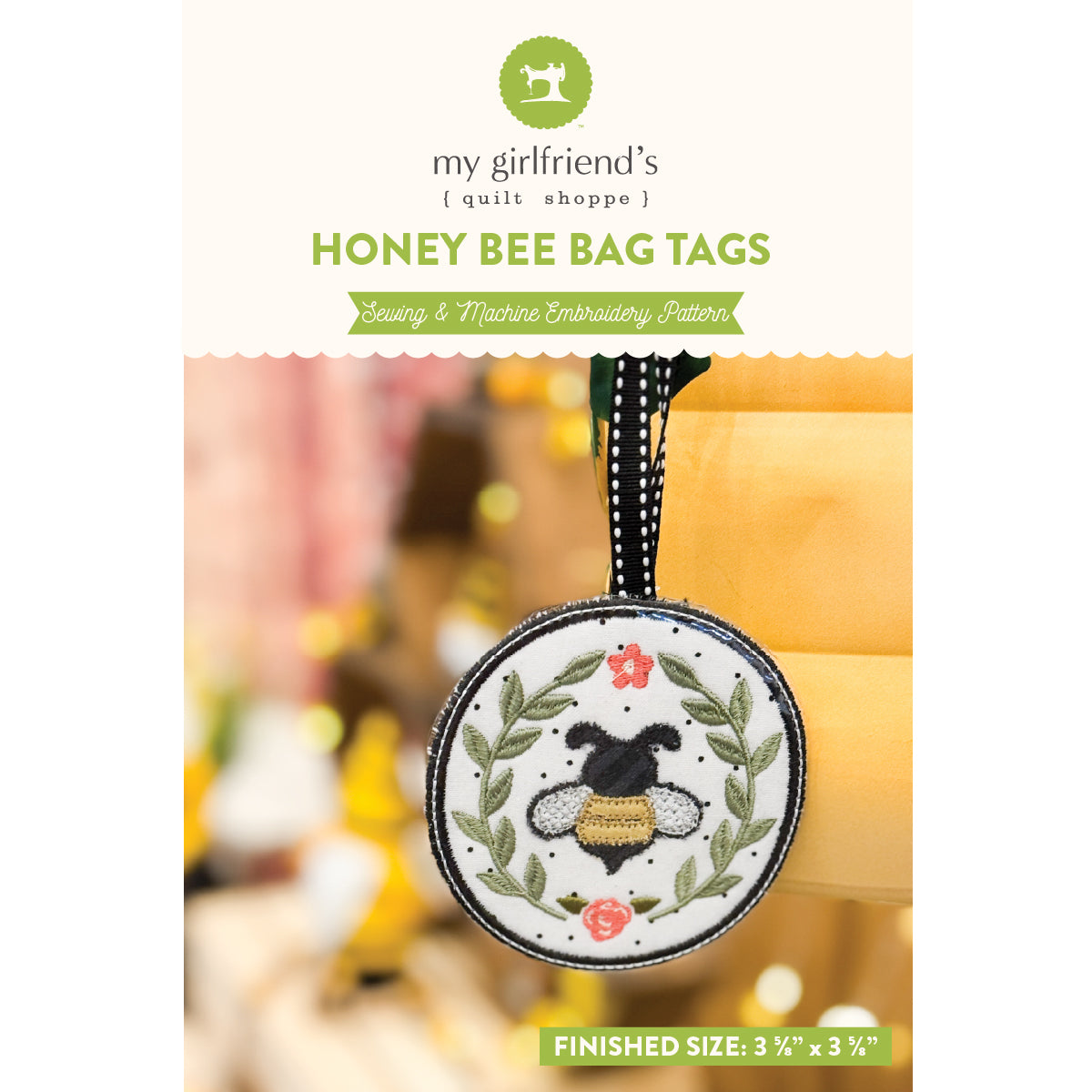 Honey bee bag tag with 'my girlfriend's quilt shoppe' branding on a white background