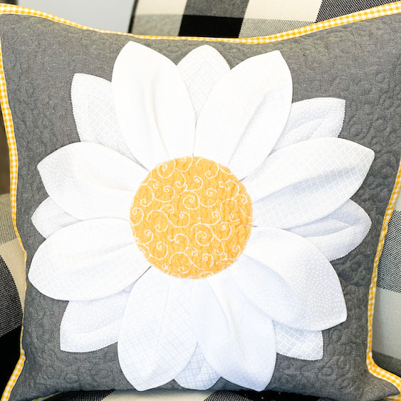 white and yellow flower pillow