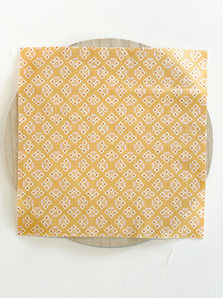 Fabric with geometric lattice flowers, honey orange color
