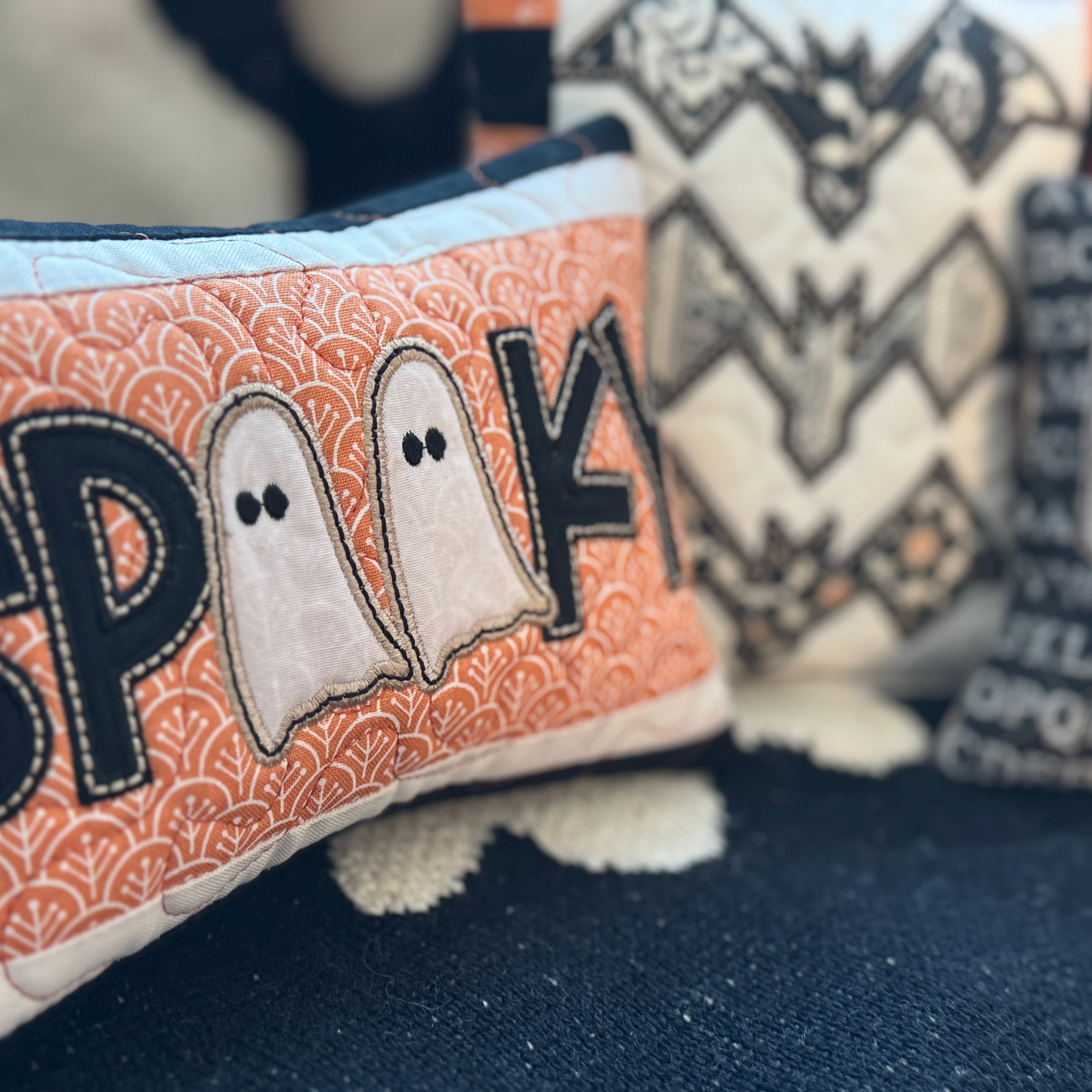 Halloween-themed plush toys with 'SPARK' and ghost designs on a dark background