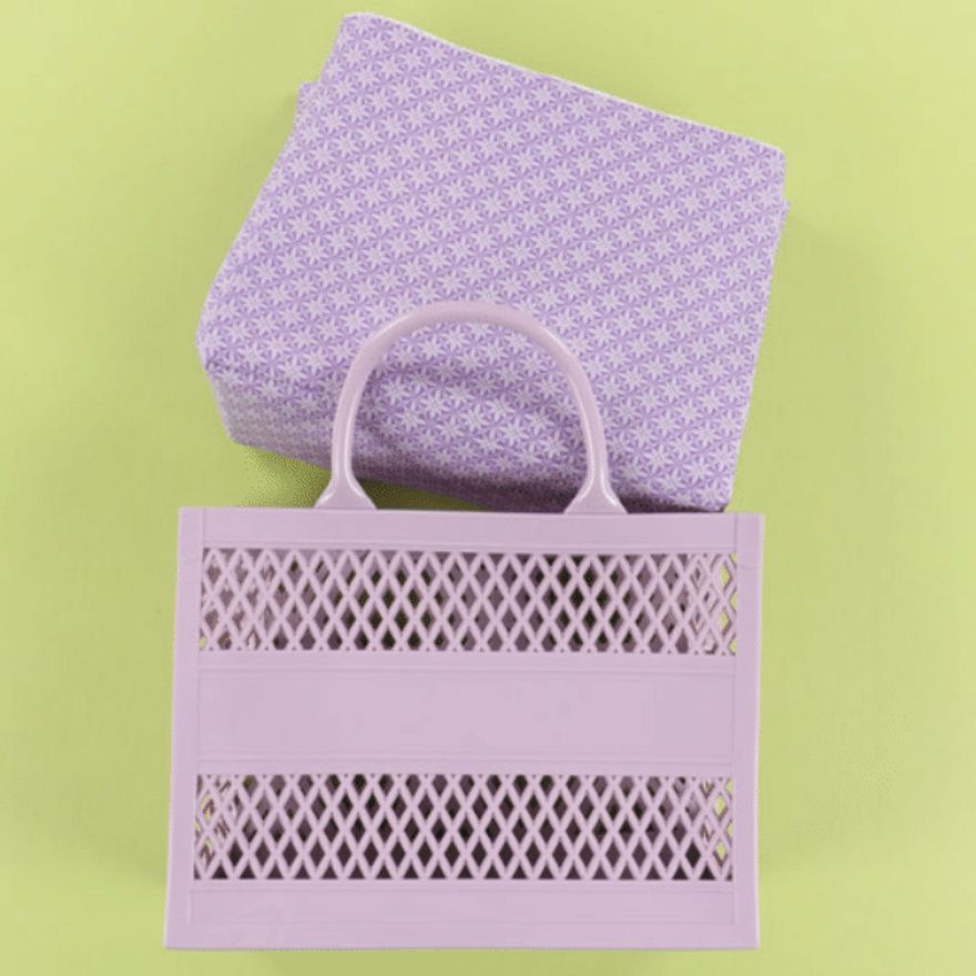 Purple patterned bag and tote on a green background