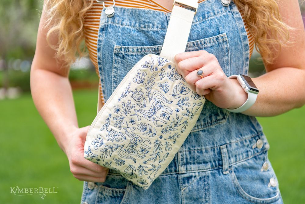 Canvas cream zipper pouch with blue embroidery designs