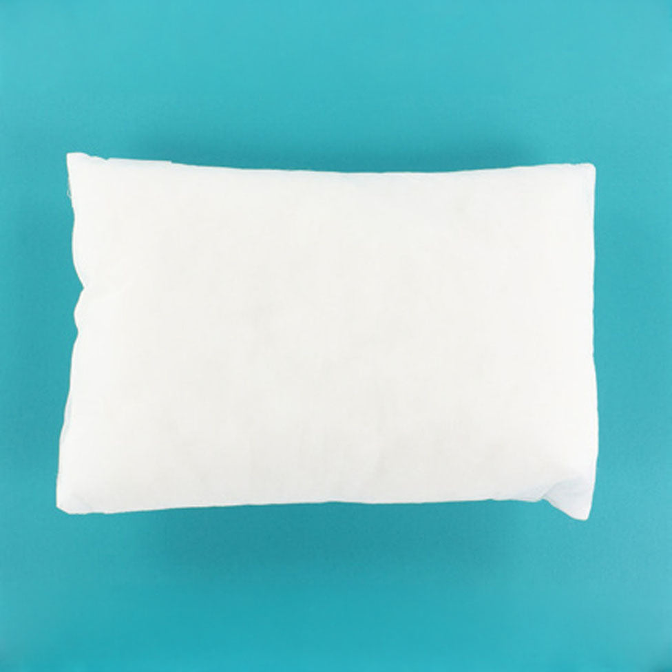 A plain white rectangular pillow or cushion shown from above on a bright turquoise-blue background.