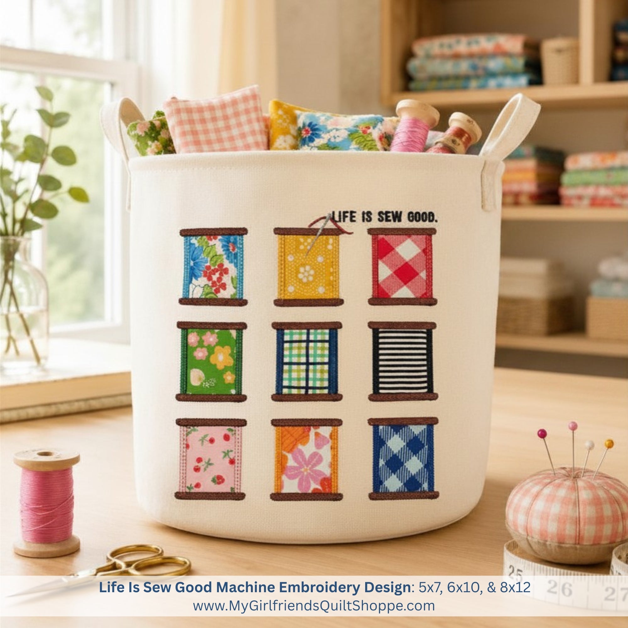 White laundry basket with colorful spool design and 'Life is Sew Good' text, placed on a wooden surface.