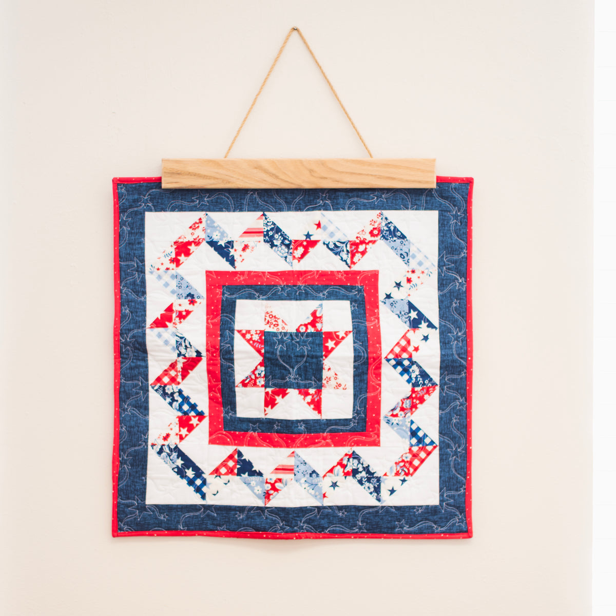 Quilt with red, white, and blue pattern hanging on a wall 18" wall hanger
