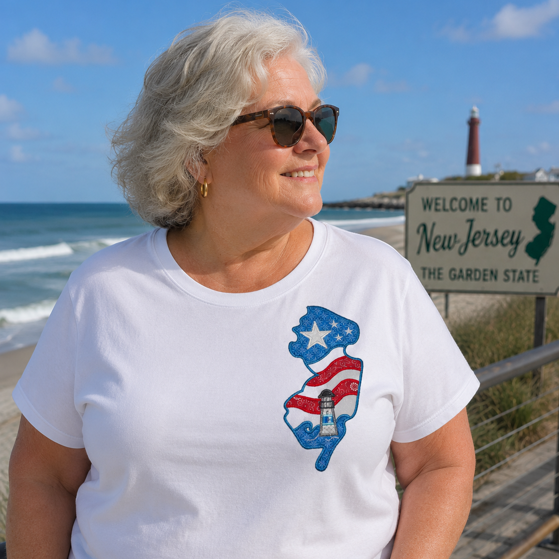 Woman wearing a white t-shirt with a New Jersey map design by the beach