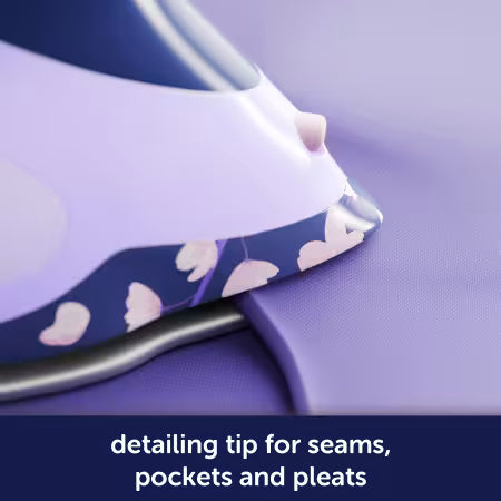 Ironing board with floral pattern ironing a piece of fabric, text 'detailing tip for seams, pockets and pleats' below.