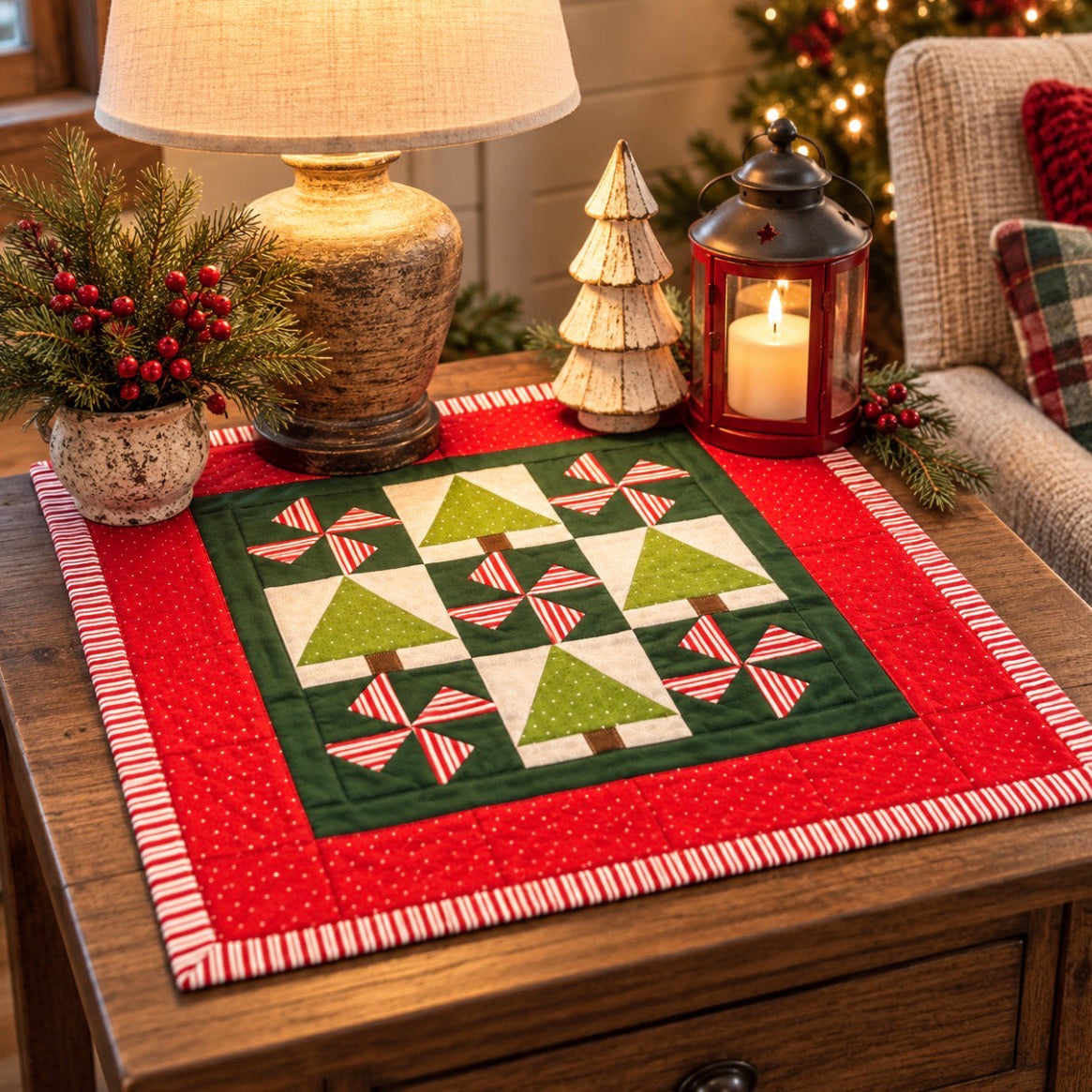 A square quilted table runner with a Christmas tree and bow pattern, styled on a wooden table in a cozy holiday living room setting.