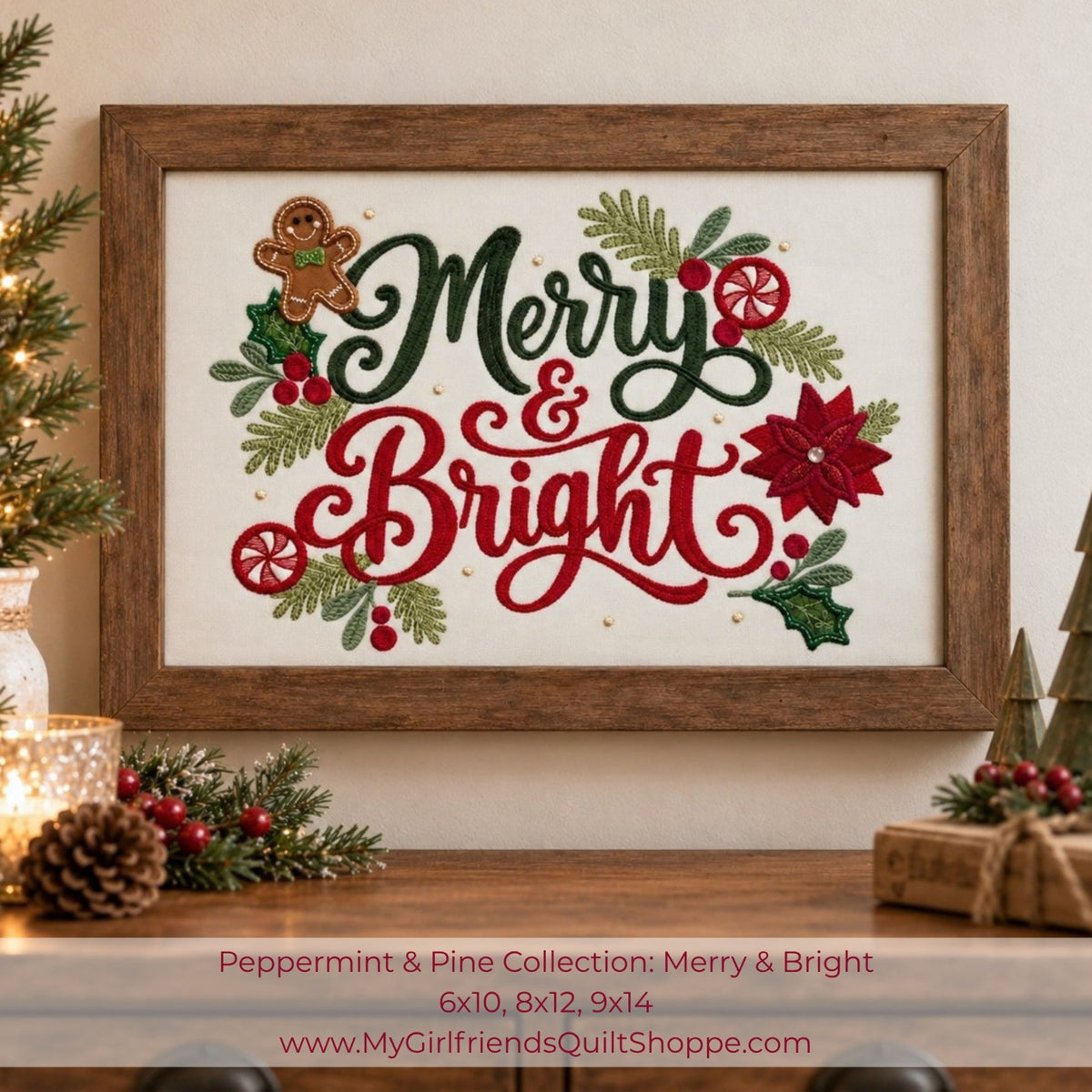 Framed Christmas cross-stitch artwork with the words “Merry & Bright” in dark green and red lettering, surrounded by holly leaves, pinecones, red berries, and a gingerbread cookie. The piece is displayed on a wooden surface with holiday decor, including a lit candle, pinecones, and wrapped gifts, against a warm beige wall.