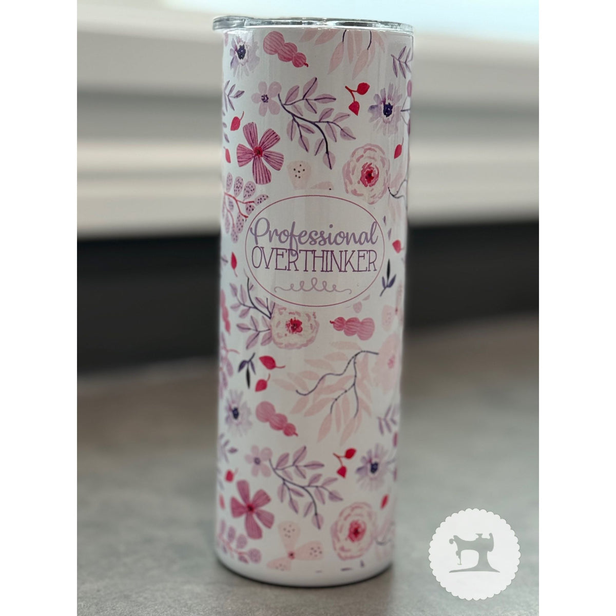 Tumbler with floral design and text 'Professional Overthinker' on a neutral background