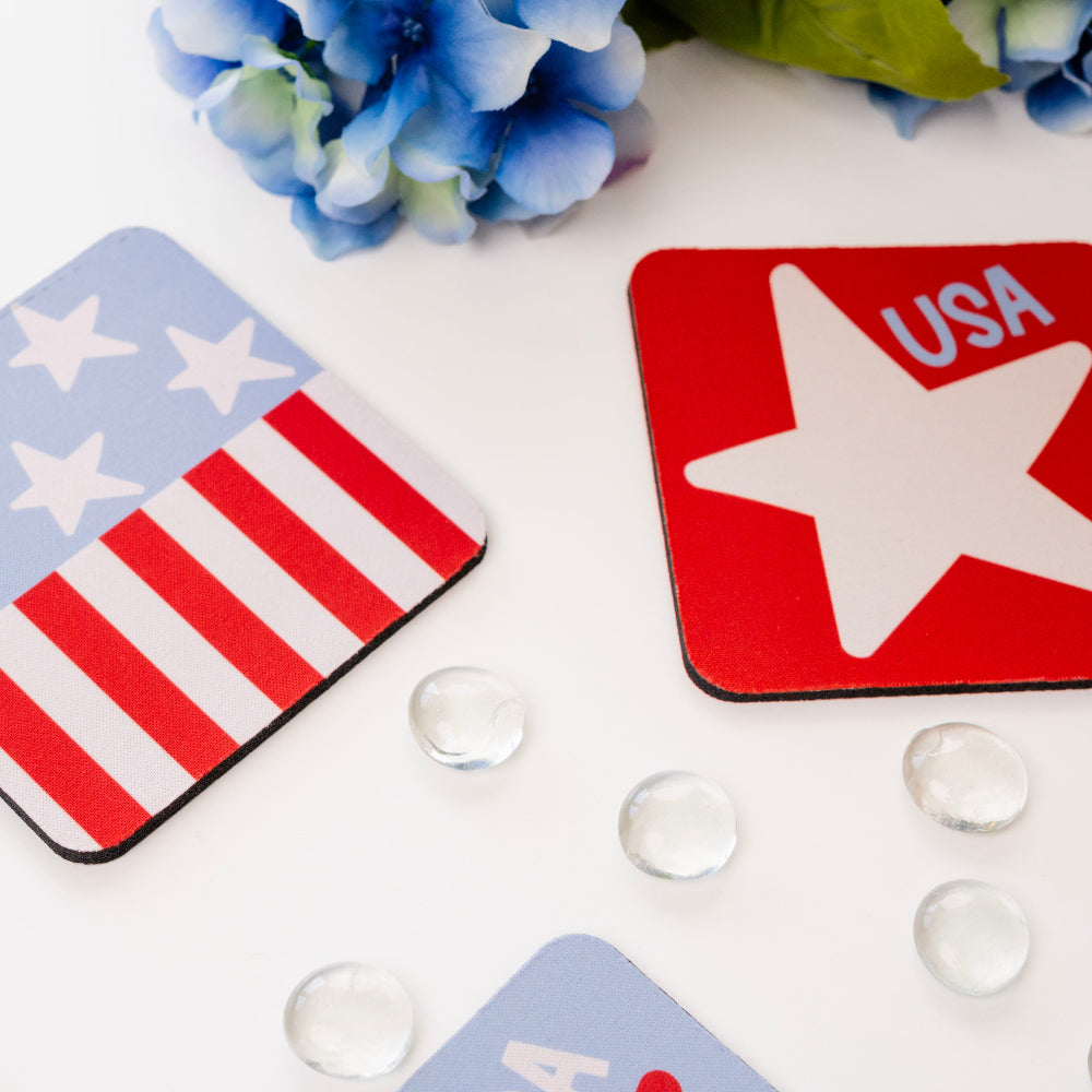 Coasters with American flag and star design on a white surface with flowers and clear beads.