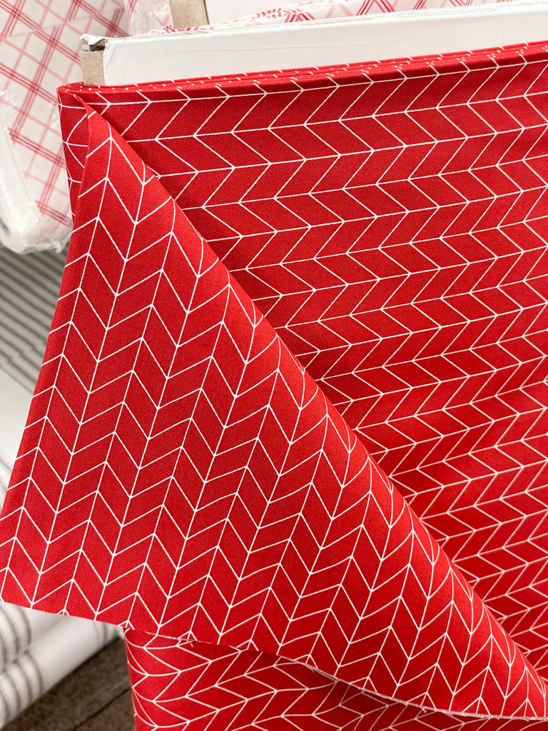 red fabric with a white pattern 