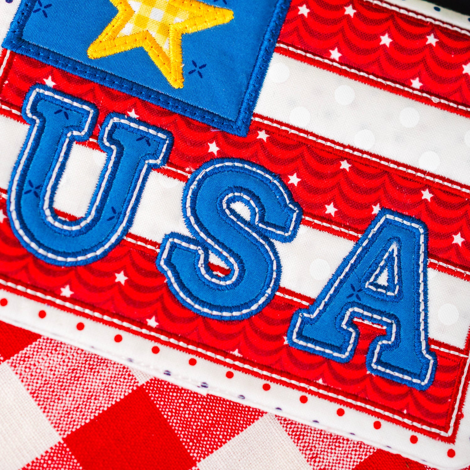 Fabric patch with 'USA' text and star on a red, white, and blue checkered background