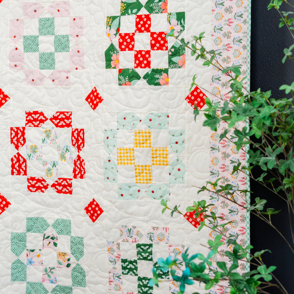 Quilt with colorful patchwork patterns on a white background