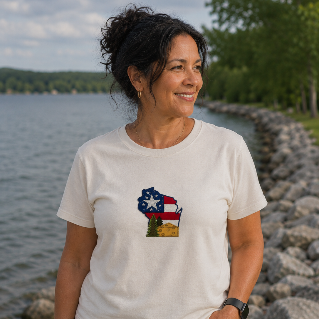 Woman wearing a t-shirt with a graphic design by a body of water