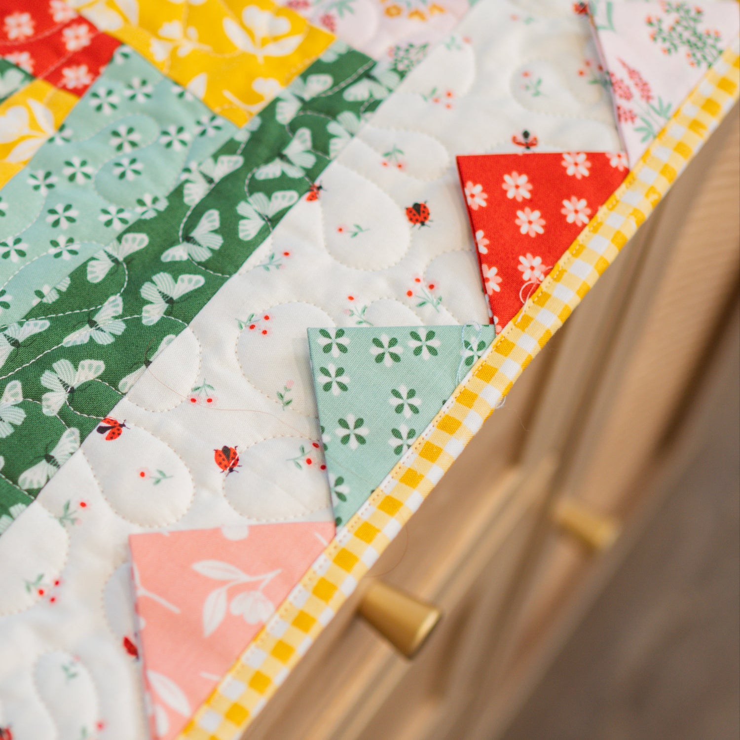 Colorful patchwork quilt with various patterns and colors.