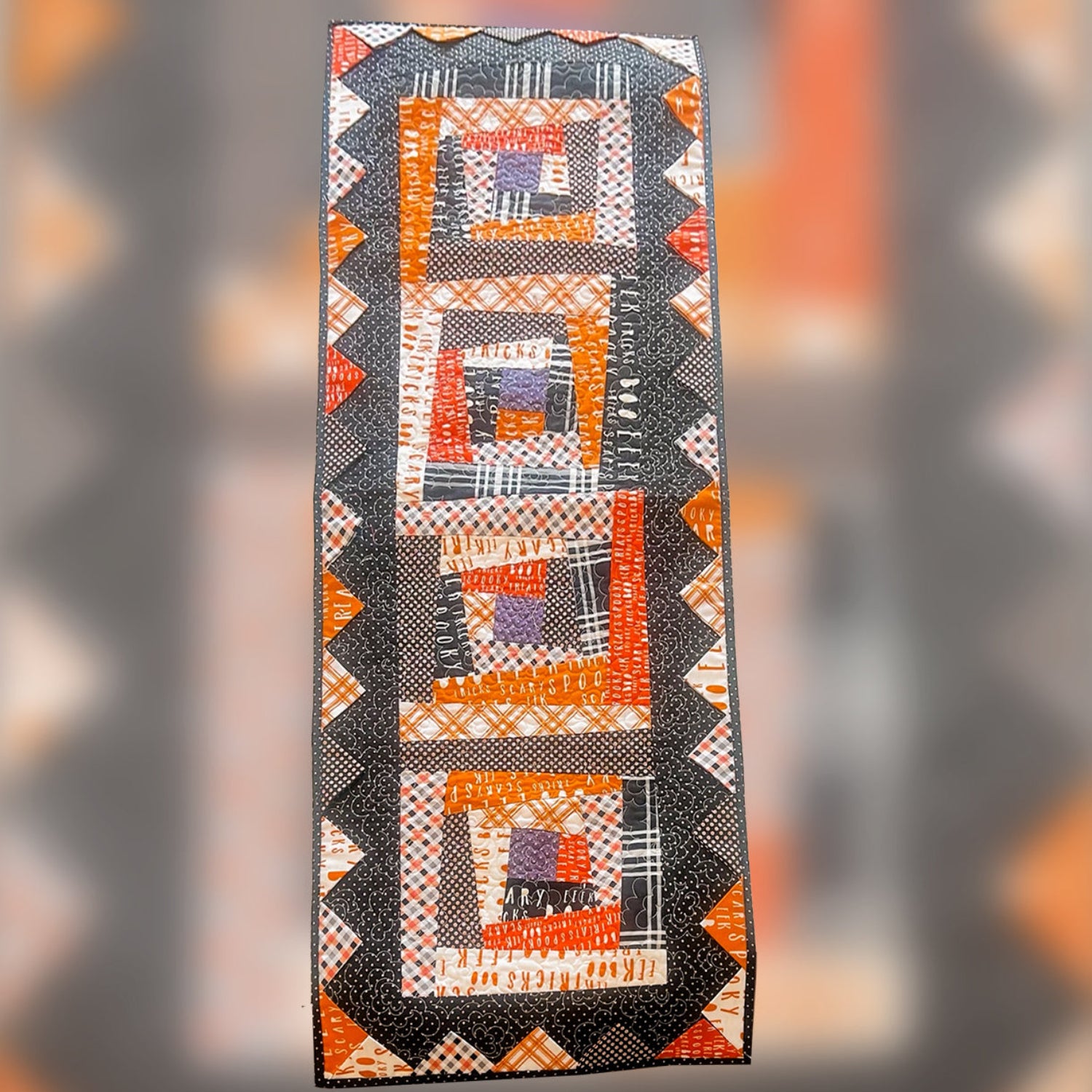 Quilt with geometric pattern on a blurred background halloween pattern