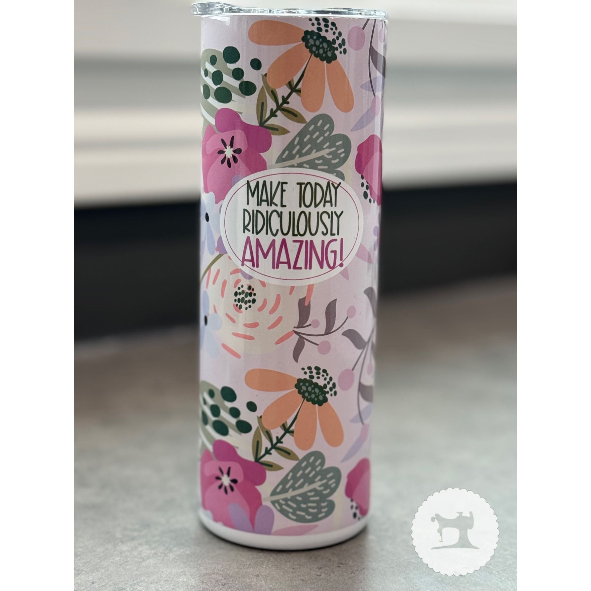 Tumbler with floral design and motivational quote on a neutral background