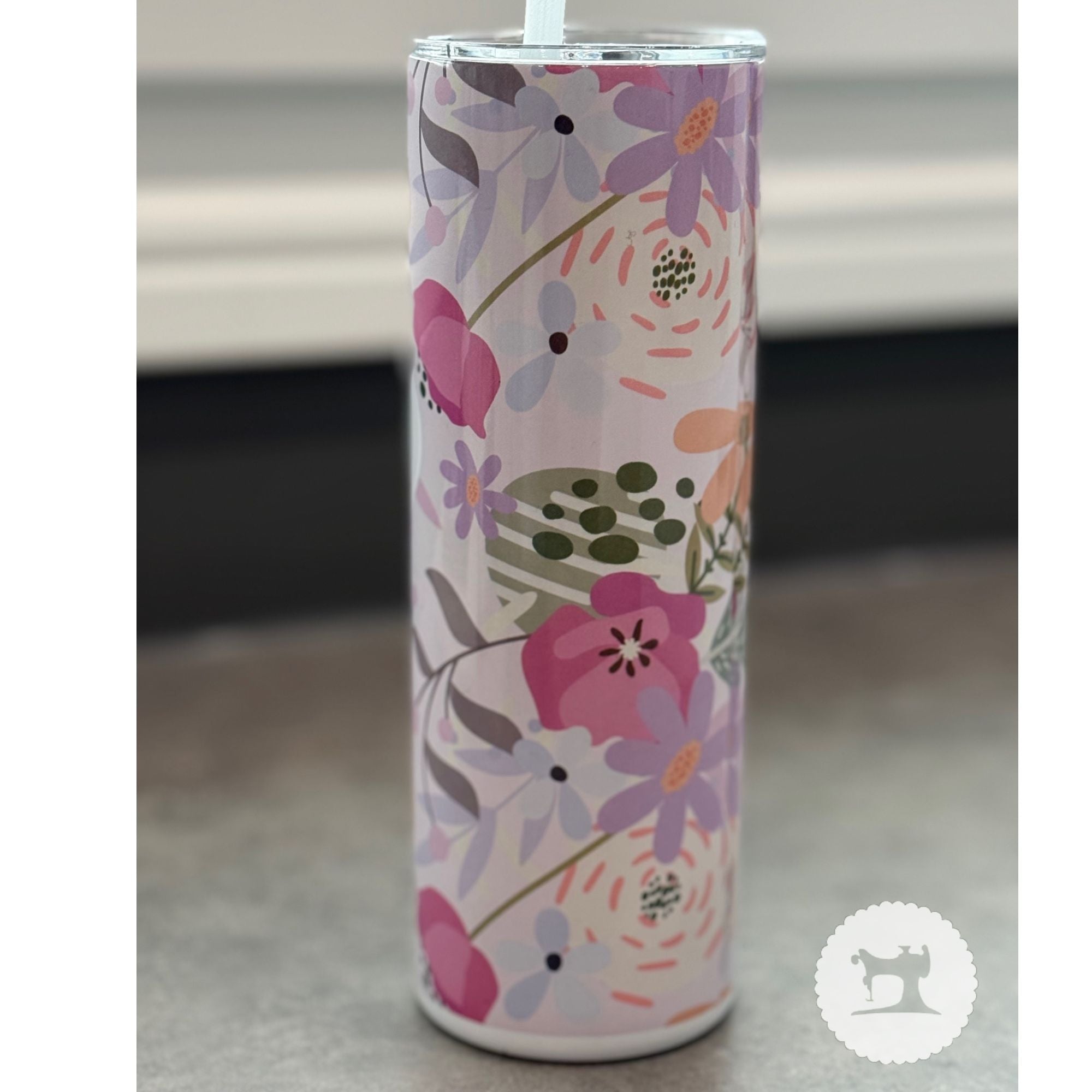 Tumbler with floral design on a neutral background