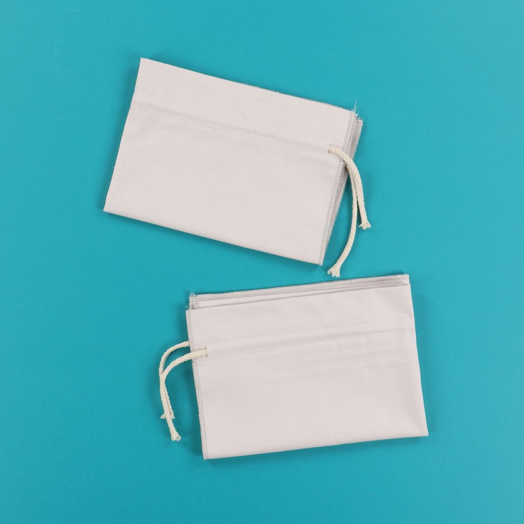 Two white cinche sacks from Kimberbell