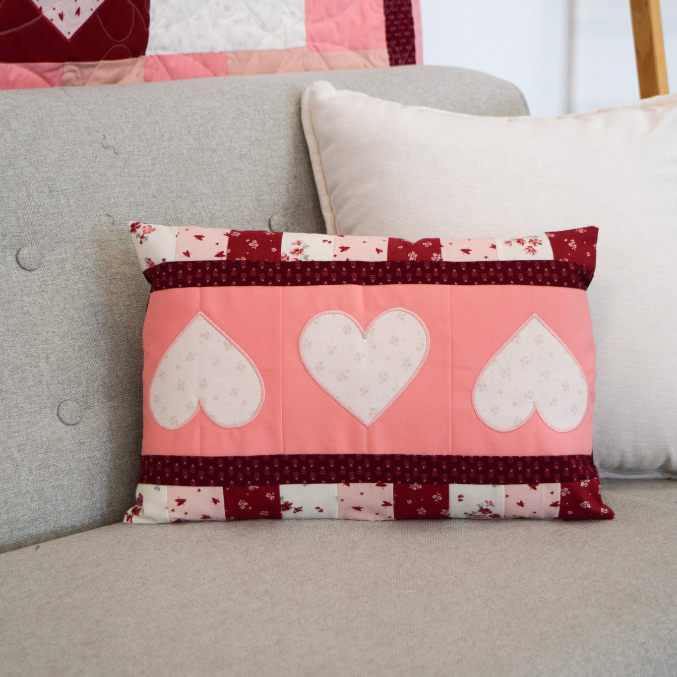 Quilted pillow with heart design on a sofa