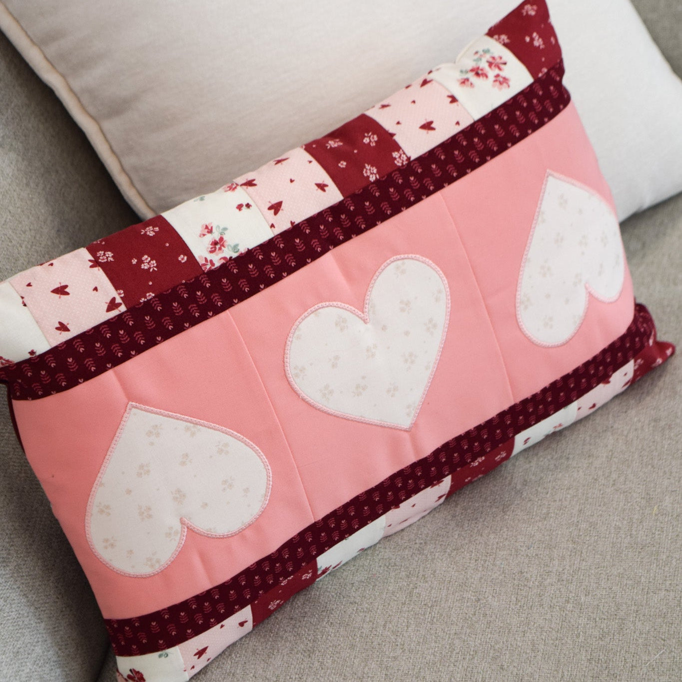 Decorative pillow with heart patterns on a couch