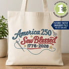 Tote bag with 'America 250 Sew Blessed 1776-2026' design on a wooden surface.