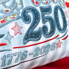 Decorative pillow with '250' and '1776-2026' text on a floral background