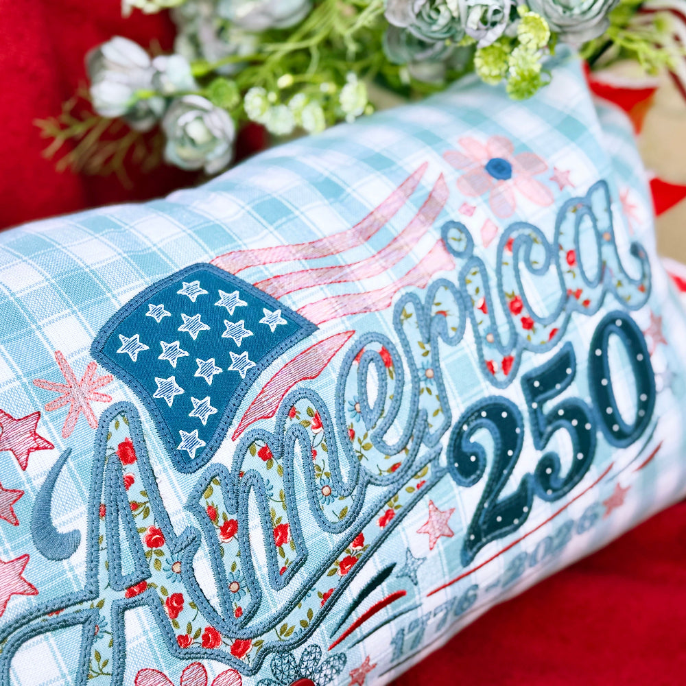 Decorative pillow with 'America 250' text and American flag design on a red background.