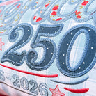 Textile item with '250' and '1776-2026' embroidery on a blue background