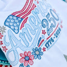 Embroidered towel with 'Happy 250th America' text and decorative elements on a white background.