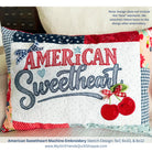 Embroidered pillow with 'American Sweetheart' design on a fabric background