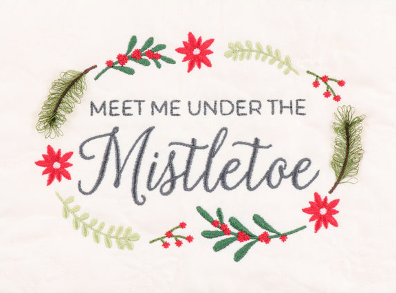 Embroidered holiday text reading 'MEET ME UNDER THE Mistletoe' in dark gray, surrounded by a wreath of red poinsettias, green pine needles, and light green leaves on a white fabric background.