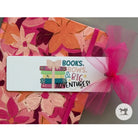Floral-patterned product with a pink bow and a tag reading 'Books, Bows, & Big Adventures!'.