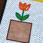 Patchwork quilt with a tulip design on a polka dot background