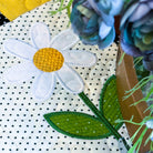Floral patch with a daisy design on a polka dot fabric background
