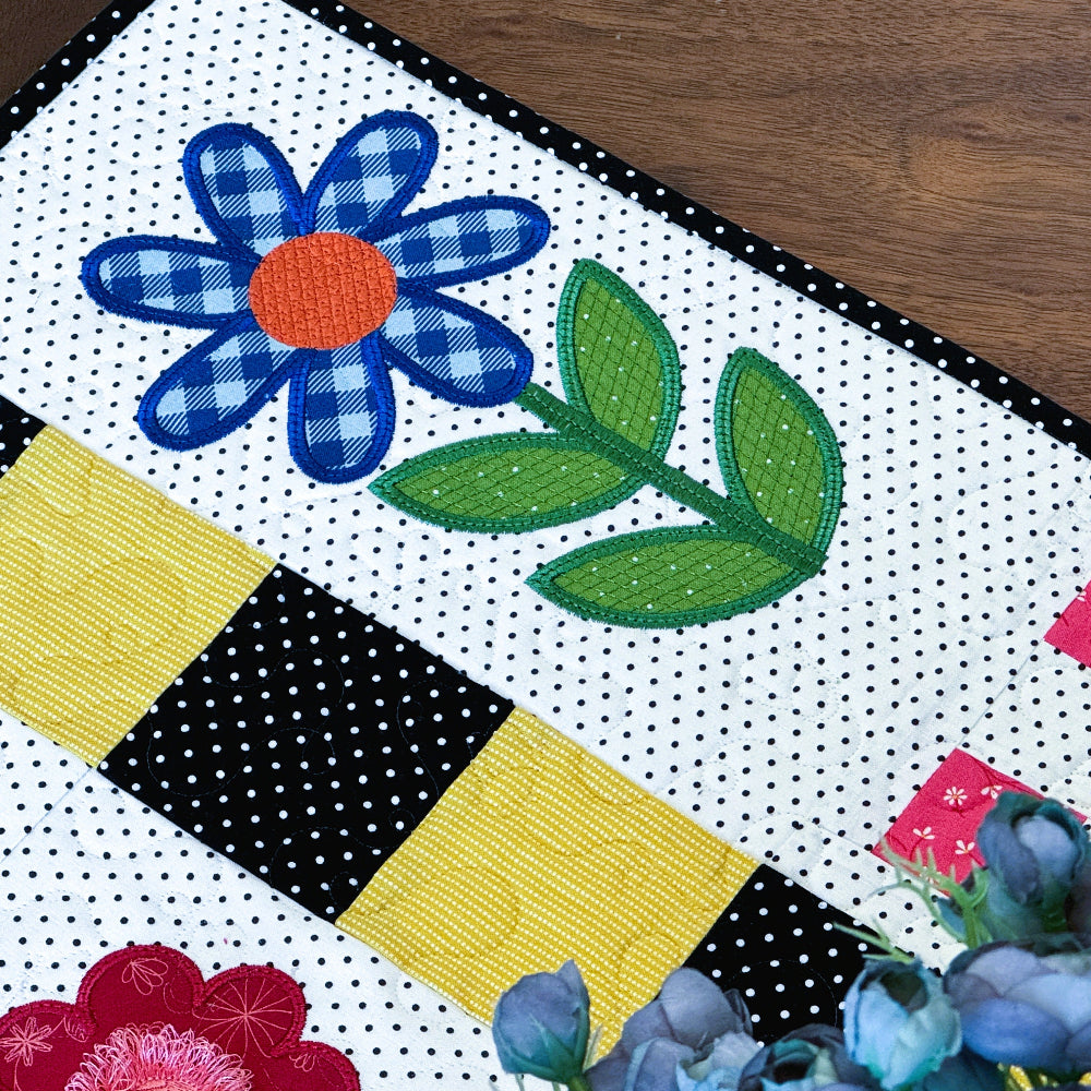 Quilt with floral patterns on a wooden surface