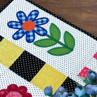 Quilt with floral patterns on a wooden surface